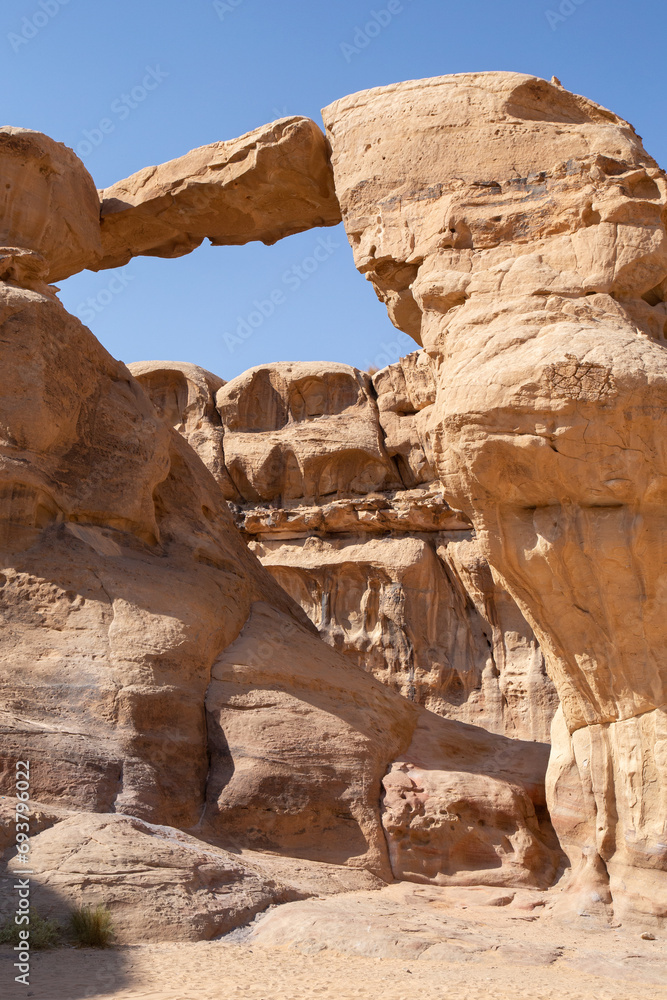 Golden rock arch formation in Wadi Rum desert, Jordan