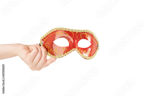 Carnival mask in hand, red vintage masquerade accessory isolated