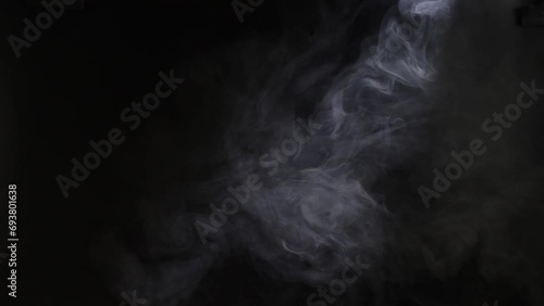 Cloud of smoke against a black background, white vapor photo