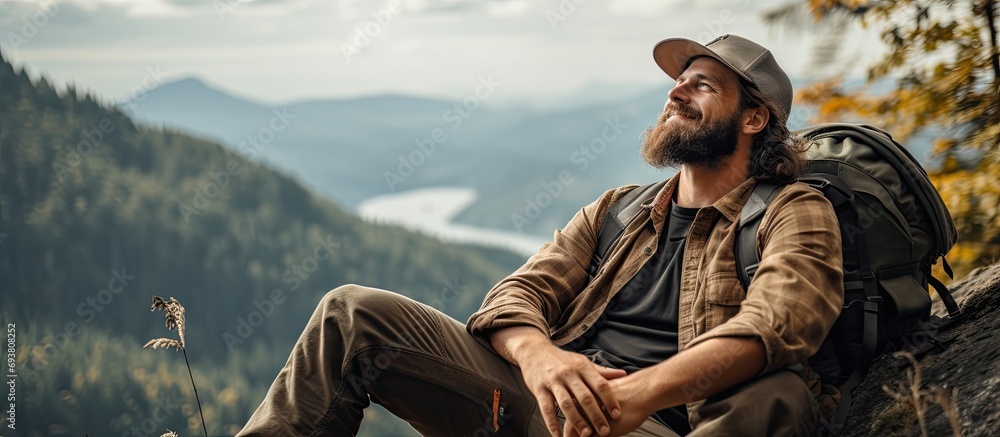 Hiker rests on cliff, prioritizing mental health and exercise in pandemic lockdown. - obrazy, fototapety, plakaty 
