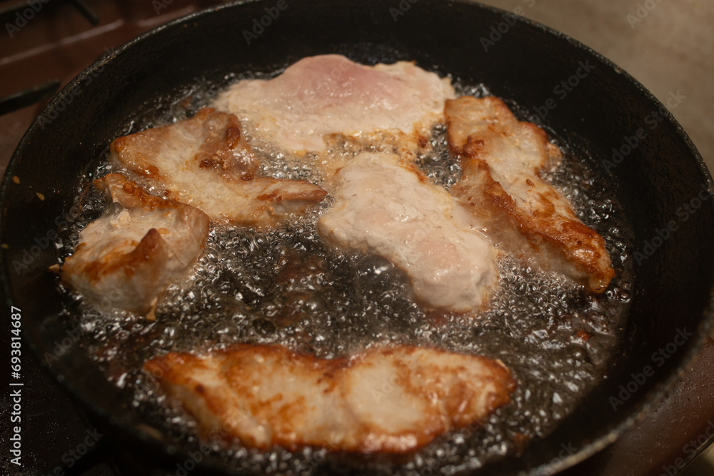 Pork meat boiling in oil, soft focus close up Pork meat boiling in oil, soft focus close up