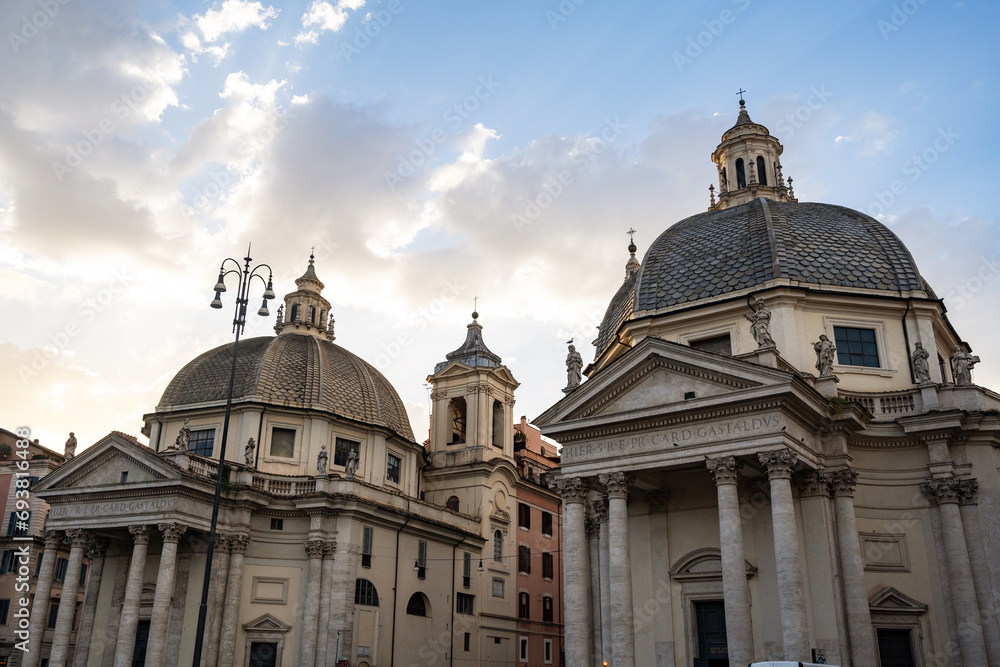Scenic view of the twin churches churches of Santa Maria Montesanto and Santa Maria Miracoli in Piazza del Popolo, iconic square and major landmark in Rome