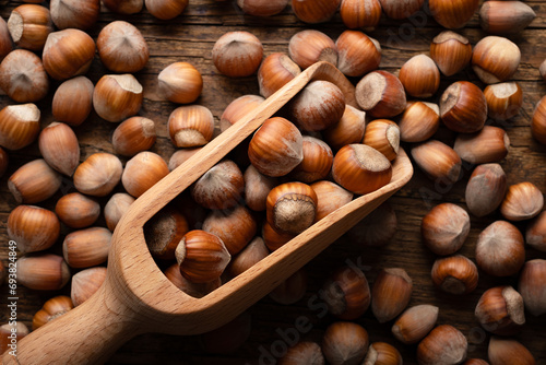 Hazelnut nuts in wooden scoop close up. Food photography