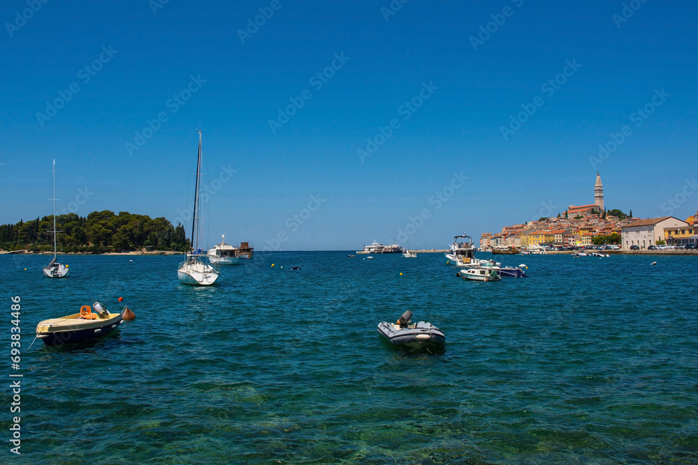 Boats on the historic waterfront of the medieval coastal town of Rovinj in Istria, Croatia. Saint Euphemia Church is far right