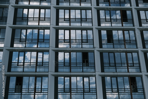 Clouds Reflected in Windows of Modern Office Building..