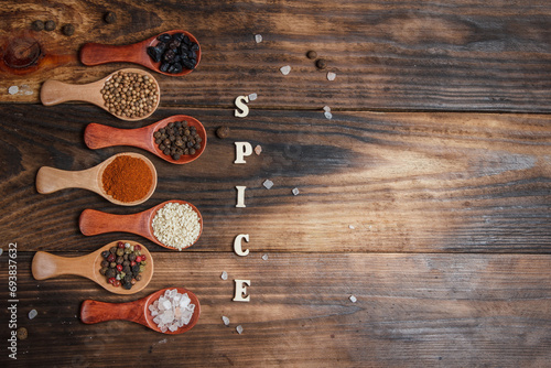 Many different spices in wooden spoons on a wooden background  background with spices  spices in spoons