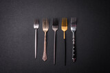Kitchen fork made of steel on a dark textured background