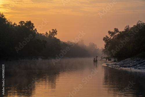 Scenic sunrise landscape with fog on water channel in the Sundarbans national park, a UNESCO World Heritage site, Bangladesh	
