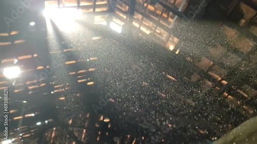 Dust particles are clearly visible to sunlight inside the warehouse photo