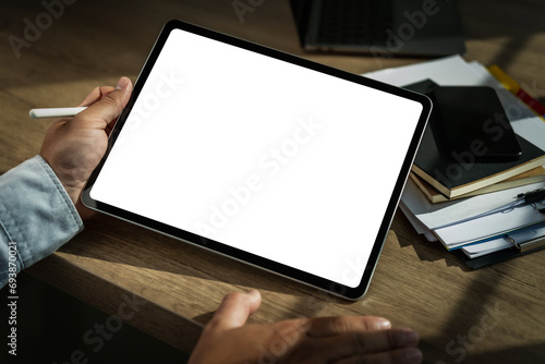 A businessman holds a mockup. iPad digital tablet with blank screen Mockup replaces your design mockup in the office. photo