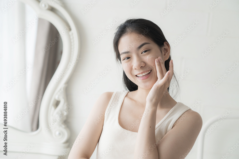 Beautiful Asian Young Woman Her Perfect Soft Face Skin, Uses Advanced Organic Cream, Smiles Look at Camera. Happy Female Enjoying Her Morning Beauty Routine, Natural Beauty, Cosmetic Products Beautiful Asian Young Woman Her Perfect Soft Face Skin, Uses Advanced Organic Cream, Smiles Look at Camera. Happy Female Enjoying Her Morning Beauty Routine, Natural Beauty, Cosmetic Products