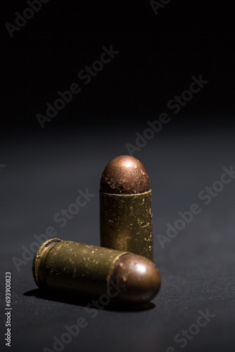 Firearm bullets on a black background, 9mm pistol cartridge