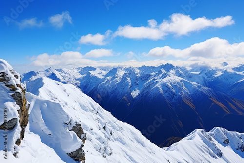 The breathtaking view from a mountaintop, with snow-capped peaks stretching into the distance under a clear blue sky.
