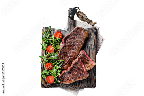 Roasted cap rump or Top sirloin beef meat steak on wooden board with salad. Transparent background. Isolated. photo