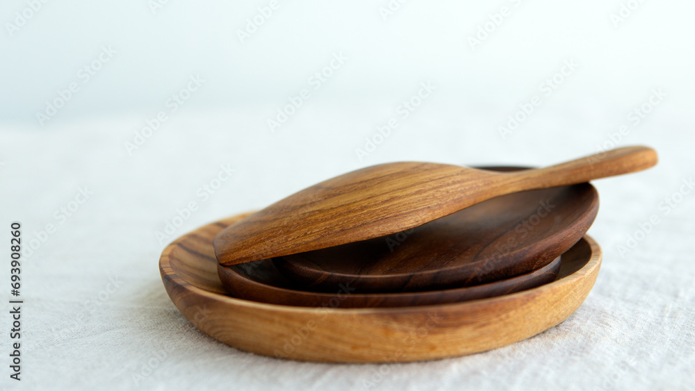 wooden plates and wooden scoop on a light background wooden plates and wooden scoop on a light background