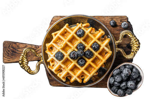 Fresh Belgian waffles with blueberry and Syrup in skillet.  Transparent background. Isolated.