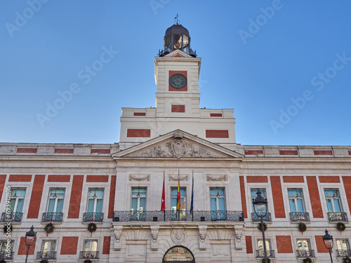 Facade of Casa de Correos, former post office building and currently headquarters of the Madrid regional government, with the famous clock on top. Puerta del Sol, Madrid, Spain, Europe photo