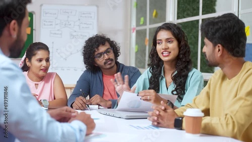 Team members congratulating woman for idea given during presentation meeting at office - concept of woman appreciation, workplace culture and motivation