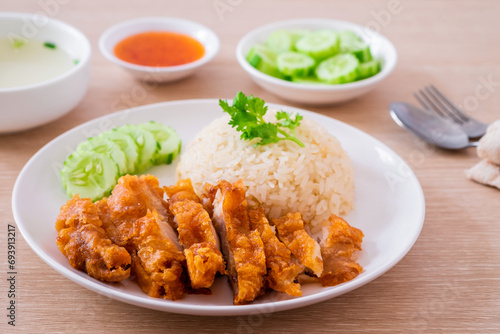 Hainanese chicken rice with fried chicken or oily rice with fried chicken and chili sauce
