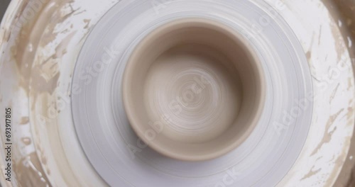 ceramic cup on on pottery wheel, Close up, top view photo