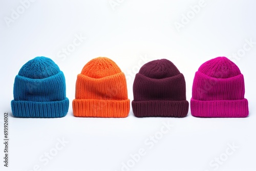 Four different colored hats neatly arranged on a white surface. Perfect for fashion and accessories-related projects