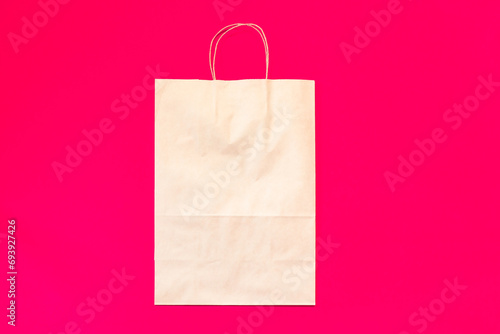 Top view brown paper shopping bag on colourful background, Mock-up of blank brown paper shopping bag and copy space. Flat lay.