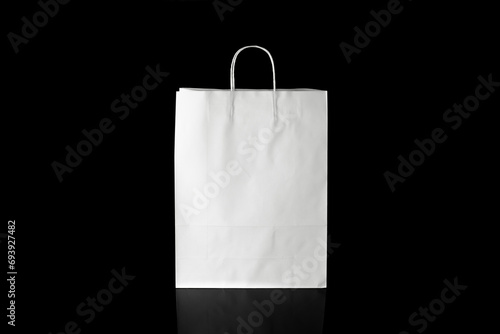 Recyclable craft paper bag for purchases, gifts and takeaway food mock up on black background. Environmentally friendly than single-use plastic bags