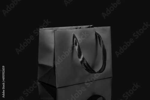 Recyclable craft paper bag for purchases, gifts and takeaway food mock up on black background. Environmentally friendly than single-use plastic bags