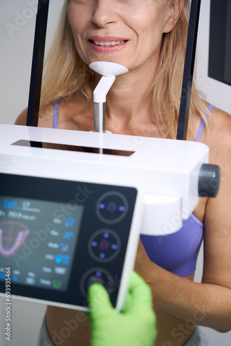 Adult female patient getting CBCT scan in dentistry clinic photo