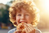 A young boy enjoying a delicious doughnut covered in colorful sprinkles. Perfect for food blogs, advertisements, or any sweet-themed projects