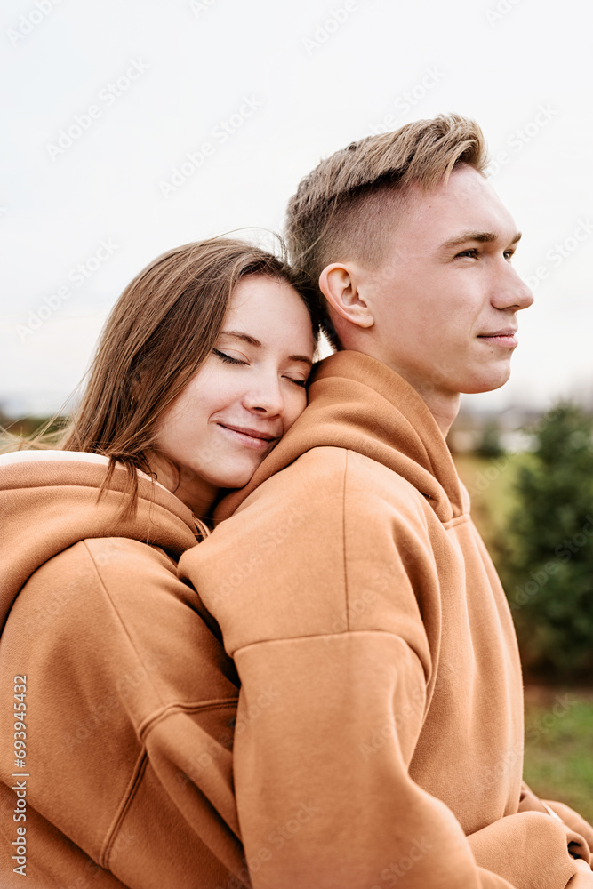 young loving couple wearing trendy colored peach fuzz sweatshirts young loving couple wearing trendy colored peach fuzz sweatshirts