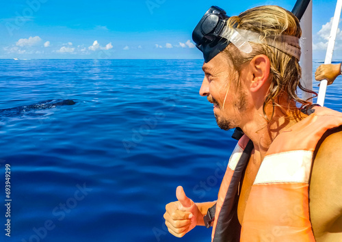 Man person takes selfie with huge whale shark Cancun Mexico. photo