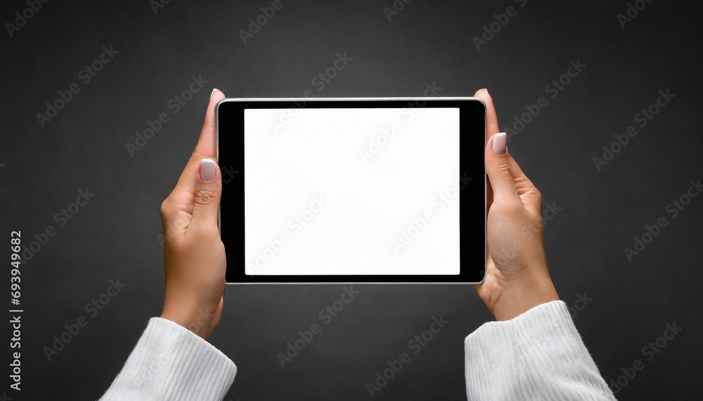 Hands holding white screen tablet, isolated on dark background Hands holding white screen tablet, isolated on dark background