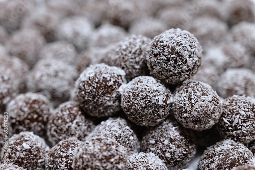 Rum balls in coconut. Traditional unbaked Czech sweets for Christmas and winter. Raw sweet food with cocoa and coconut.