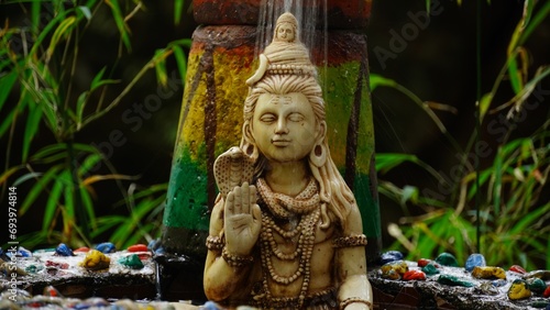 closeup of showering on the sculpture of lord shiva photo