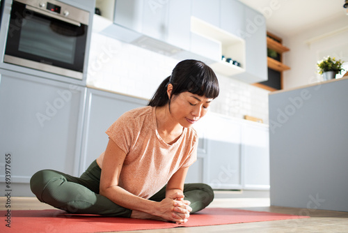 Young woman doing yoga on home floor