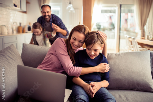 Happy family using laptop on the couch