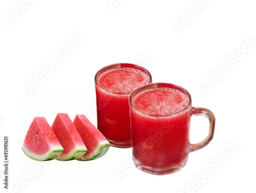The white background in the picture is red watermelon juice in a clear glass and a fresh red watermelon cut in half next to each other.