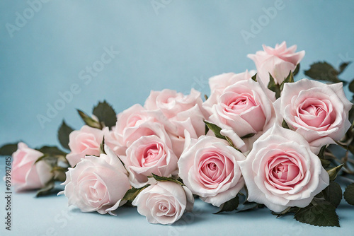 Romantic rose arrangement against a pastel pink background