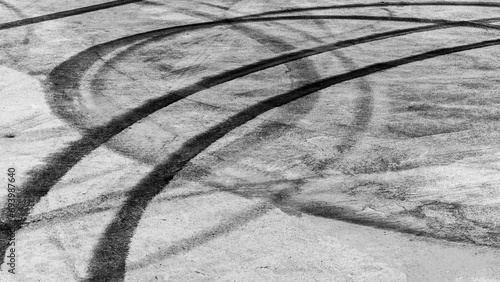 Tire track mark on asphalt tarmac road race track texture and background, Abstract background black tire tracks skid on asphalt road in racing circuit, Tire mark skid mark on asphalt road.