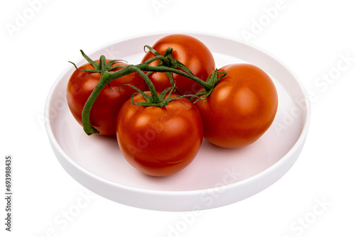 Branch of tomatoes on a white plate isolated on white © Yarr