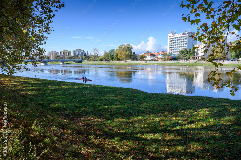 View of Vah riverbank with different buildings and kayakers (Piestany, Slovakia)