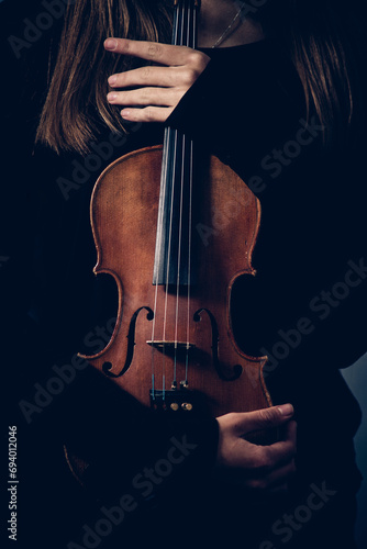 violin in the hands of a girl close-up