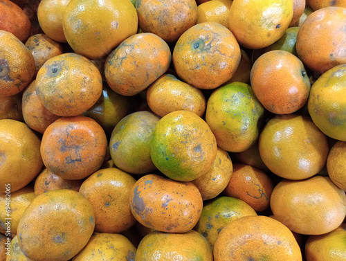 Fresh orange fruit in local market. Piles of local orange fruits are sold in traditional markets.
