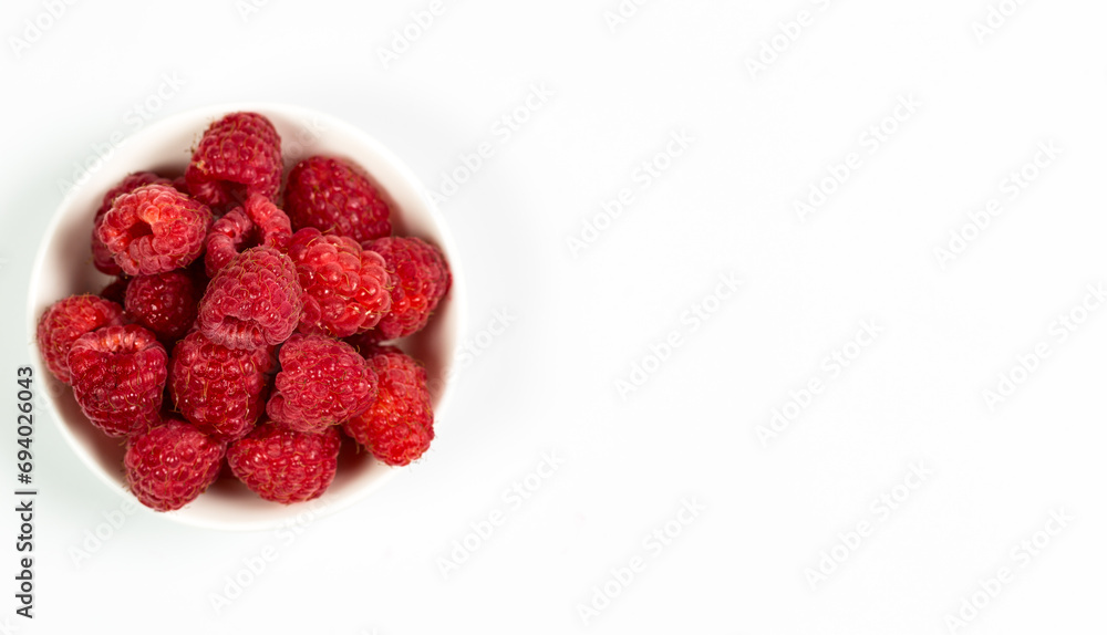 Fresh red raspberries on a white background, raspberries for dessert Fresh red raspberries on a white background, raspberries for dessert