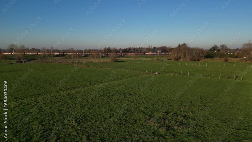 Freight Train Cargo Transport Through Green Landscape Fields Farming Industrial Upwards Panning Freight Train Cargo Transport Through Green Landscape Fields Farming Industrial Upwards Panning