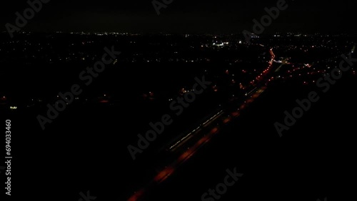 Trains Crossing at Night Multiple while panning to reveal city village windows photo