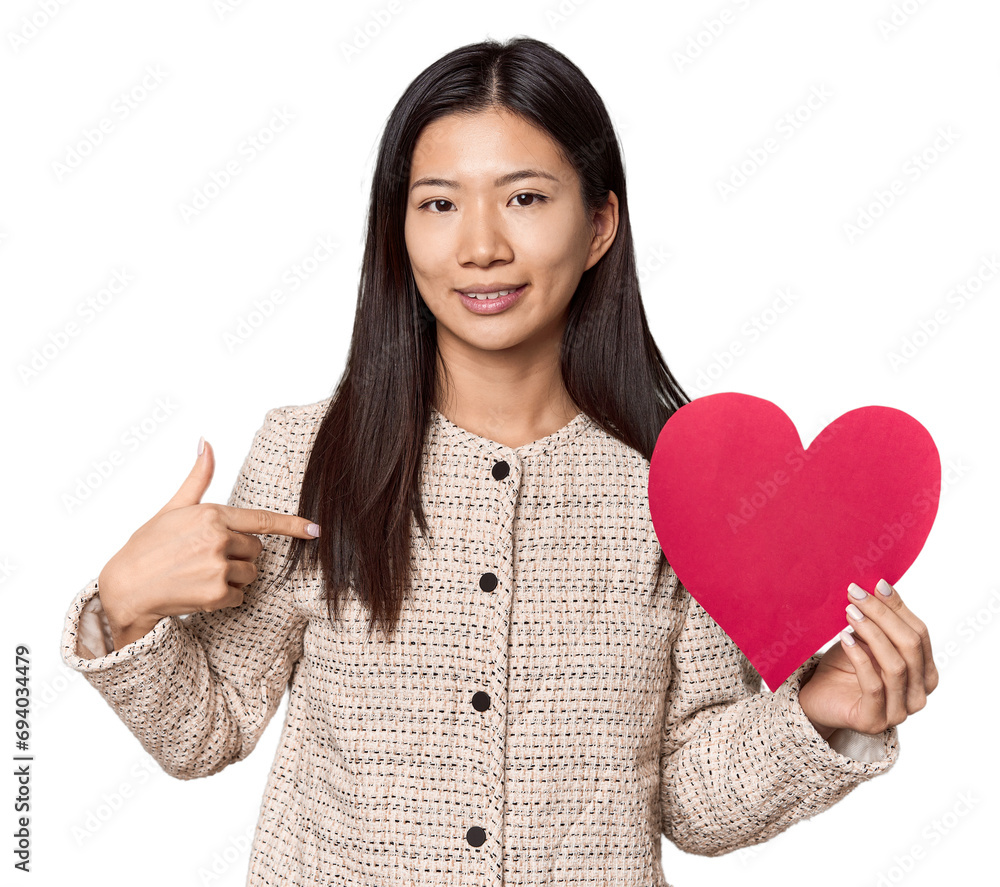 Chinese woman holding Valentine's heart person pointing by hand to a shirt copy space, proud and confident Chinese woman holding Valentine's heart person pointing by hand to a shirt copy space, proud and confident