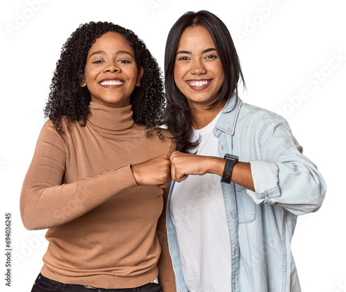 Young Latina friends celebrating with a fist bump photo