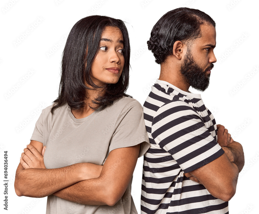 Young Latin man apologizing, couple back-to-back, studio Young Latin man apologizing, couple back-to-back, studio